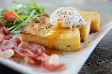 egg benedict with bacon on wood background , breakfast
