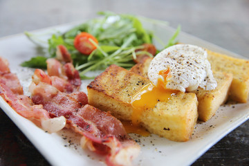 egg benedict with bacon on wood background , breakfast
