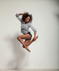 young beautiful dancer jump in a studio