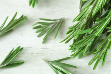 Fresh rosemary twigs on wooden background