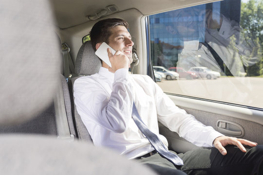 businessman talking on the phone in car