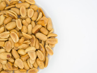 close up shot of roasted peanuts and sliced garlics seasoning wi