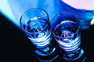 drinking glasses with ice close-up on a dark background