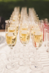 close up of a catering banquet table with glasses of champagne at wedding reception