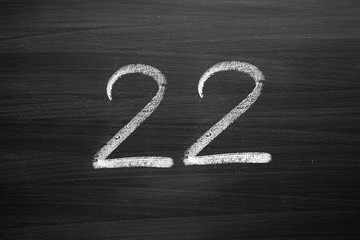 number twenty two enumeration written with a chalk on the blackboard