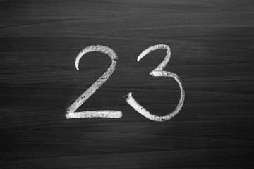 number twenty three enumeration written with a chalk on the blackboard