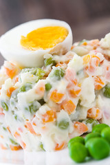 Russian salad on a rustic wooden table


