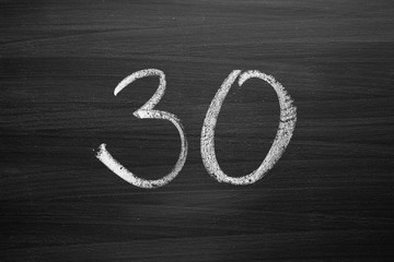 number thirty enumeration written with a chalk on the blackboard