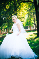 Fototapeta premium portrait the bride on the background of the park