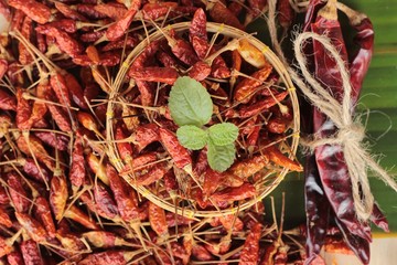 Dried red chili peppers on wood background.