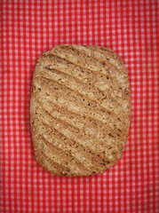 Fresh baked bread on tartan table background