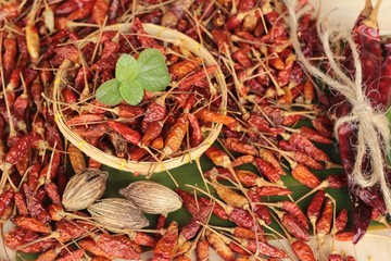 Dried red chili peppers on wood background.