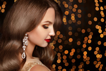 Makeup. Jewelry. Beautiful smiling woman model with expensive go