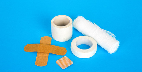 Set of medical plasters and bandages. On a blue background.