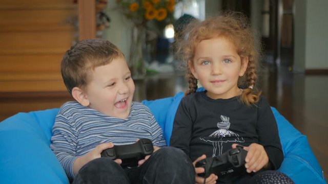 Cute boy and girl playing a game on the x-box