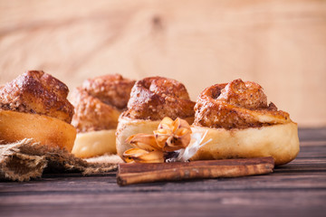 Cinnamon bun on wood background