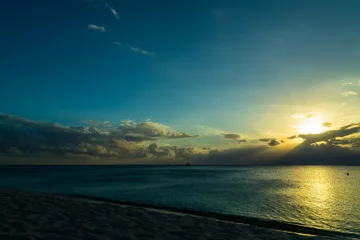 Cercles muraux Plage de Seven Mile, Grand Cayman sunset over the caribbean sea with stormy skies