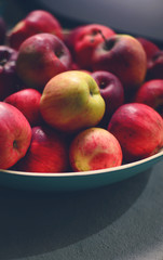 Pile of fresh apples in wooden bowl in living room - Farm food c