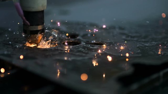 Plasma laser cutting metal sheet with sparks
