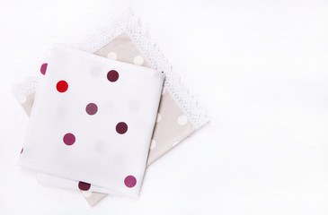 Two  napkins with polka dots on white wooden table. Top view