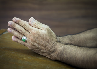 Fototapeta premium man hands praying to God on wooden background
