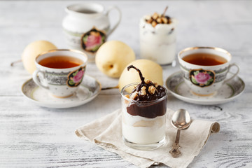 Pears in dark chocolate, sweet dessert set with modern copper co