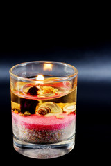 Liquid glass candles on a black background.