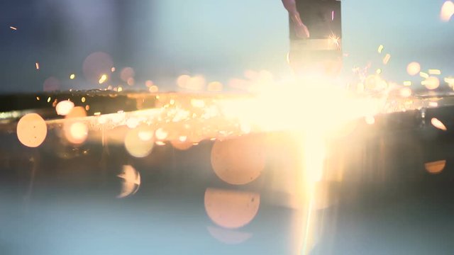 Plasma laser cutting metal sheet with sparks