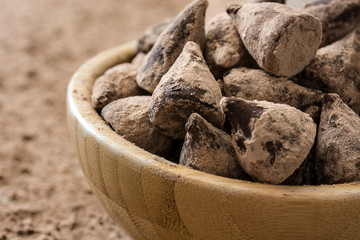 Homemade chocolate truffles in a wooden bowl

