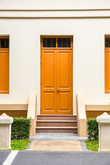 orange Door , orange window on Cream Wall on orange staircase wi