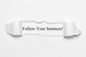 Follow Your Instincts! on white torn paper