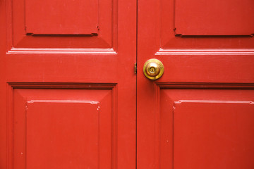 Door knob golden color with red door background