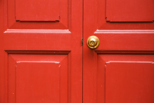 Door knob golden color with red door background
