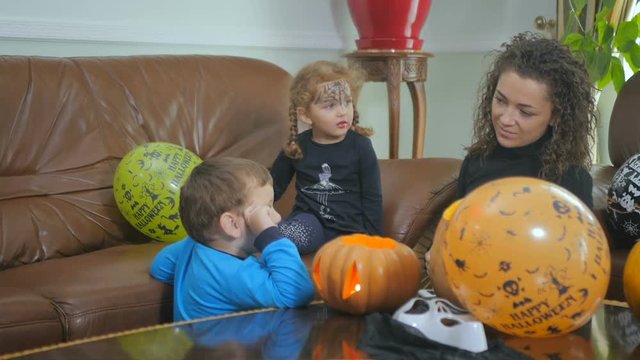 Woman preparing the little boy to Halloween party