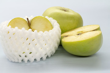 Apple green on a white table.