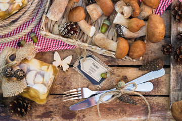 Raw white mushrooms, pine cones and decorative tag