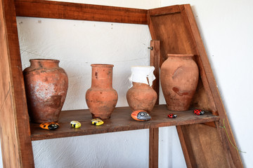 Shelves with standing on their utensils of porcelain and earthenware. Vintage kitchen utensils