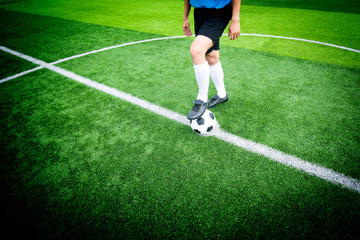 Soccer player ready to play at kick off point in soccer field.