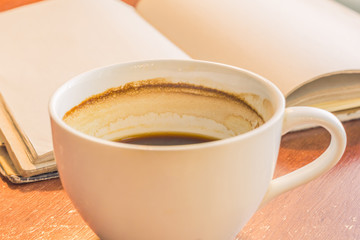 A cup of coffee on wooden table.
