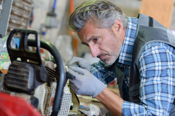 Mechanic working on gardening equipment