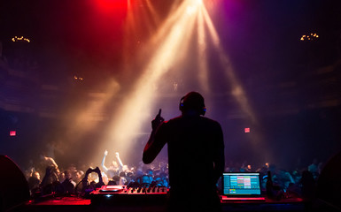 Fototapeta na wymiar Silhouette of a DJ performing at a concert