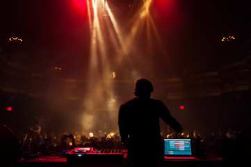 Silhouette of a DJ performing at a concert