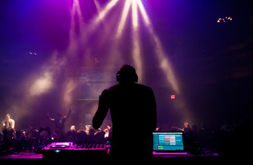 Silhouette of a DJ performing at a concert