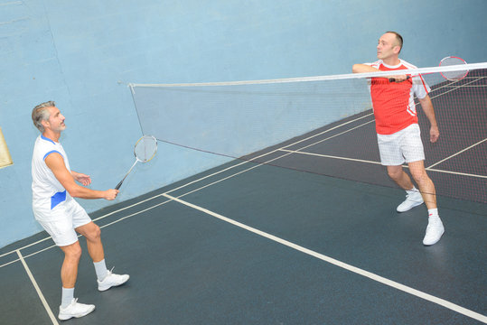 Men playing badminton