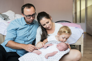 Obraz premium Mother holding daughter with chickenpox and her baby son
