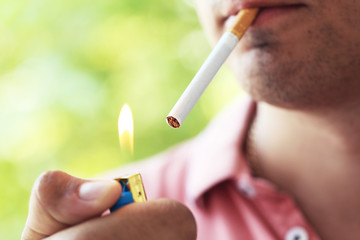 Man holding and lighting up cigarette
