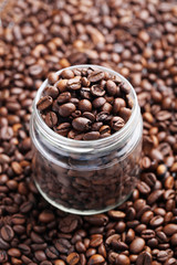 Brown roasted coffee beans in jar