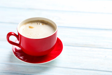 Cup of coffee on a blue wooden table