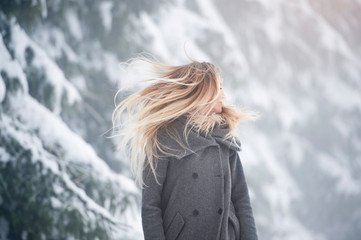 Beautiful young woman on a walk in winter nature