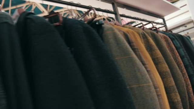 Collection of new beautiful clothes hanging on hangers in a shop